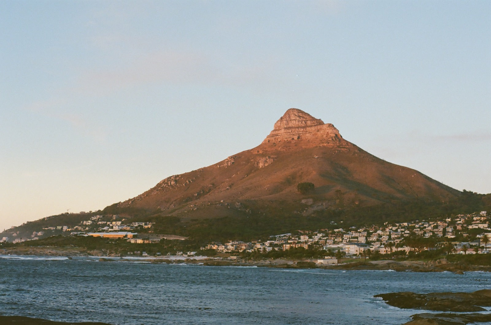 Cape Town South Africa clothing brand studio candor show photo of lions head from beta beach in camps bay as the sun sets at golden hour